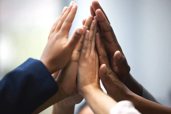 High five for teamwork. Shot of a group of unrecognizable businesspeople holding up their hands for a high five in an office. — Stock Photo, Image