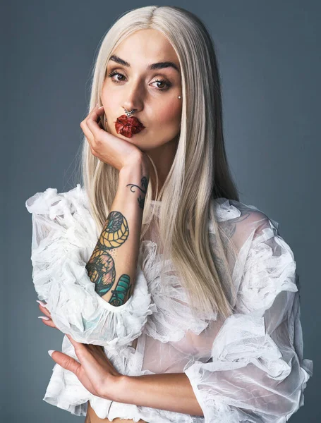 Hřeším, takže nemůžu hodit další kámen. Portrét atraktivní mladé ženy zobrazující její tetování s šedým pozadím. — Stock fotografie