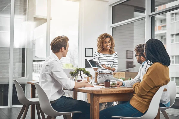 Its time to flex your problem-solving muscles. Shot of a group of businesspeople having a meeting in an office.