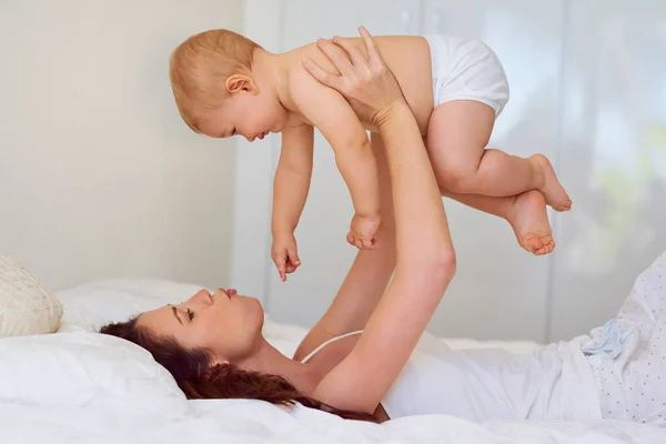 So cute I could just eat you up. Cropped shot of a mother spending quality time with her baby boy at home. — Stock Photo, Image