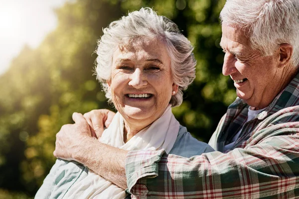 Estos son los días más felices. Toma de una feliz pareja de ancianos relajándose juntos al aire libre. —  Fotos de Stock