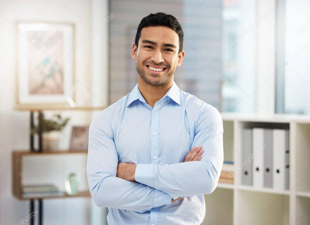 Ive worked hard to get where I am. Shot of a handsome young businessman in his office.