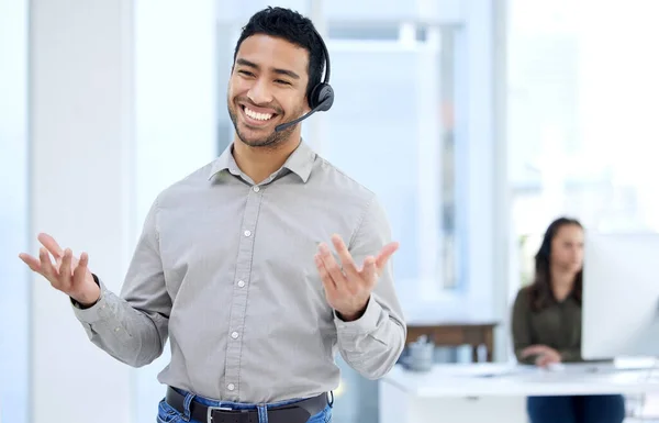 We dont like to brag, but we are the best. Portrait of a young businessman using a headset in a modern office. — Stock Photo, Image