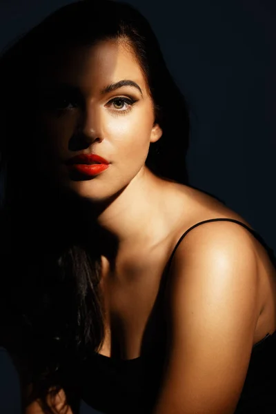 Beleza nas sombras. Retrato de estúdio de uma jovem atraente posando contra um fundo escuro. — Fotografia de Stock