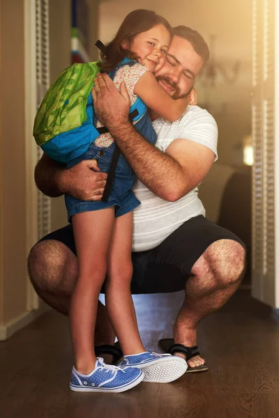 A melhor parte de ir para a escola é voltar para casa. Tiro de uma menina adorável abraçando seu pai depois de chegar em casa da escola. — Fotografia de Stock