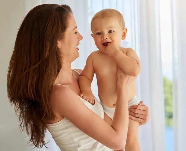 Hes full of giggles today. Cropped shot of a mother spending quality time with her baby boy at home. — Stock Photo, Image