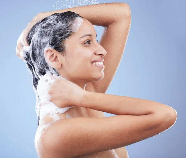 O cabelo limpo faz-me feliz. Tiro de uma jovem mulher lavando o cabelo no chuveiro contra um fundo azul. — Fotografia de Stock