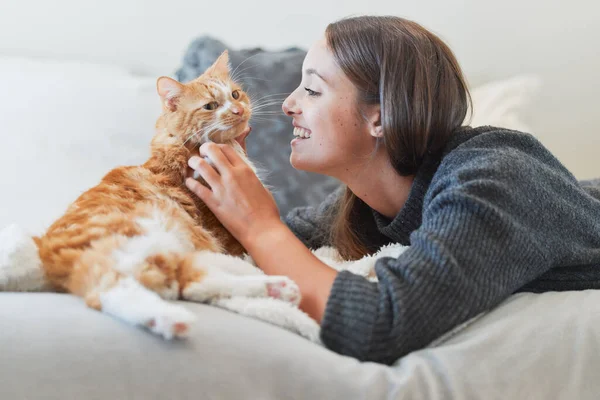 Youre such a purrfect addition to my life. Shot of a young woman petting her cat at home. — Stock Photo, Image