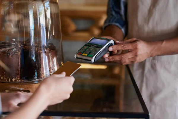 Ponlo en mi cuenta corriente. Primer plano de un cliente haciendo un pago con tarjeta de crédito en un café. — Foto de Stock