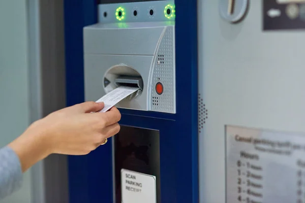 Pay or stay. Cropped shot of an unrecognizable person inserting a ticket into a meter. — Stock Photo, Image