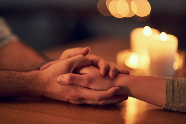Itll be okay. Closeup of two unrecognizable people holding hands over a dinner table with candle light in the background. — Stock Photo, Image
