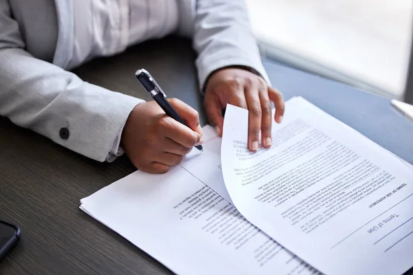 Lets get the paperwork out of the way. Cropped shot of a businesswoman signing paperwork in an office. — Stock Photo, Image