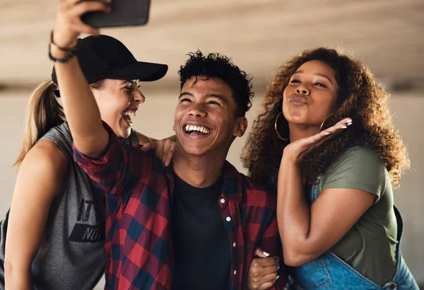 Smile for the camera my friends. Portrait of a group of cheerful young friends posing for a self portrait together while outside in a parking lot. — Stock Photo, Image