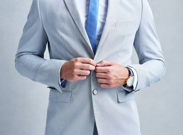 Theres no such thing as a second impression only first. Studio shot of a businessman in a grey suit posing against a grey background. — Stock Photo, Image
