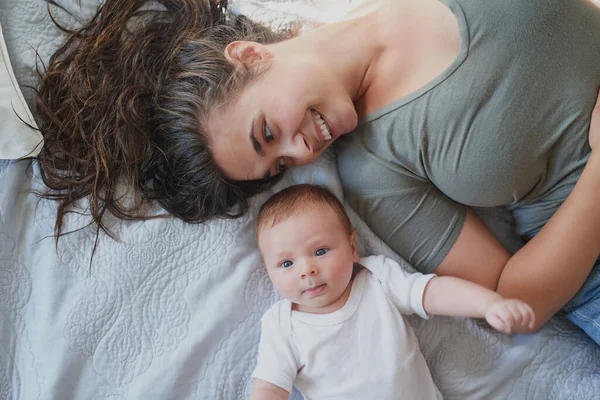 From womb-mate to room-mate. Shot of a young woman bonding with her baby boy at home. — Stock Photo, Image