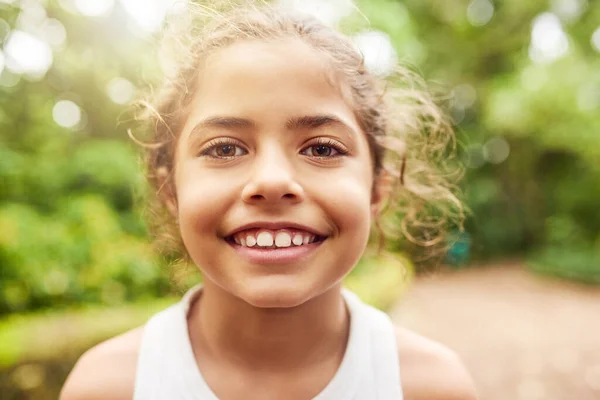 I love being in the park. Cropped portrait of an adorable little girl standing outside in the park. — Stock Photo, Image