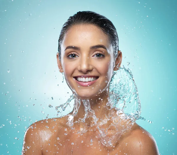 Haut so weich, dass man neidisch werden kann. Aufnahme einer jungen Frau beim Duschen vor blauem Hintergrund. — Stockfoto