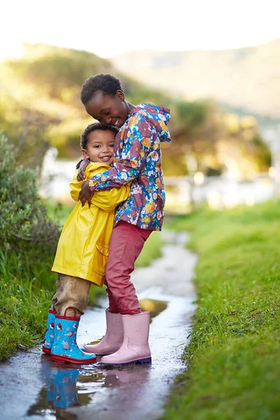 Shes the best big sister ever. Shot of a brother and sister hugging together outside. — Stock Photo, Image