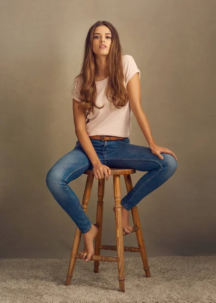 No fui hecho para ser sutil. Estudio de una hermosa joven sentada en un taburete sobre un fondo liso. —  Fotos de Stock