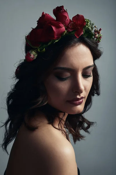 Beauty that Aphrodite would be proud of. Studio shot of a beautiful young woman wearing a floral head wreath against a grey background. — Stock Photo, Image