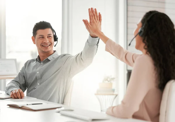 Ottimo lavoro. Girato di due giovani agenti del call center che si danno il cinque in un ufficio al lavoro. — Foto Stock