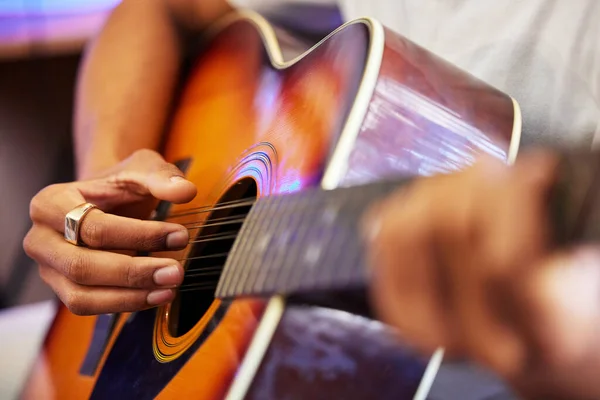 Está a acertar nas notas certas. Tiro cortado de um músico masculino irreconhecível tocando sua guitarra em casa. — Fotografia de Stock