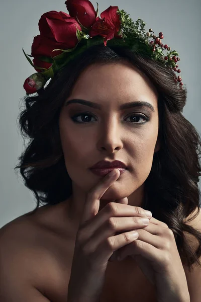 Tiene una belleza mágica. Foto de estudio de una hermosa joven con una corona floral en la cabeza sobre un fondo gris. — Foto de Stock