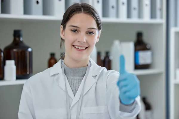 Udowadniam, że jej teorie są poprawne. Portret młodego naukowca pokazującego kciuki w laboratorium. — Zdjęcie stockowe