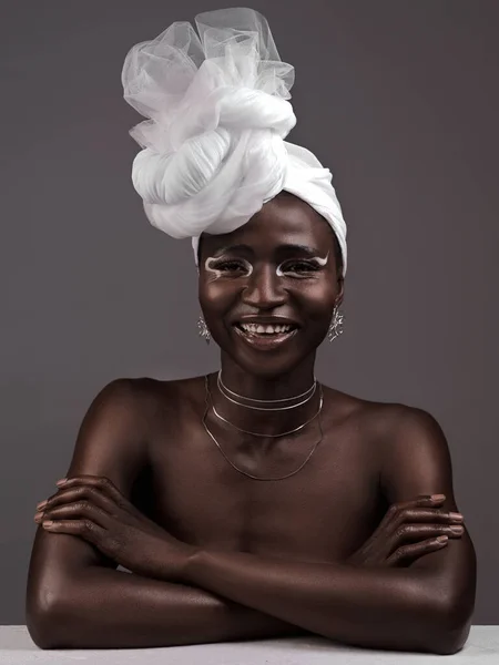 Più che un semplice panno, è la mia corona. Studio ritratto di una giovane donna attraente in posa in tradizionale abbigliamento africano su uno sfondo grigio. — Foto Stock