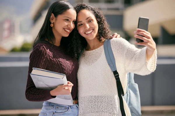 Nebyla by to vysoká bez mého oblíbeného. Zastřelen dvě mladé ženy brát selfie spolu na vysoké škole. — Stock fotografie