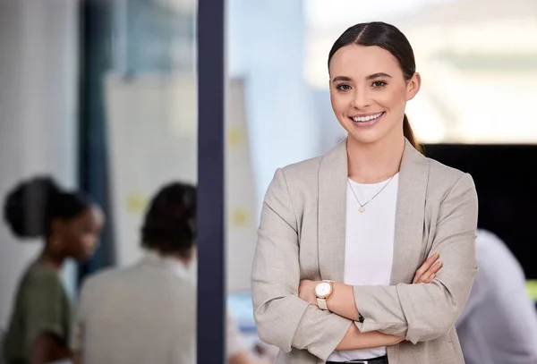 As soon as you trust yourself, you will know how to live. Shot of a businesswoman smiling at a business meeting in a modern office.