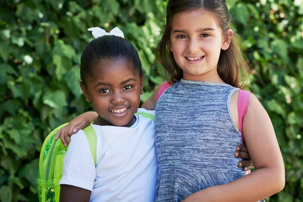 Friends forever. Shot of two little girls wearing backpacks outside in nature. — Stock Photo, Image