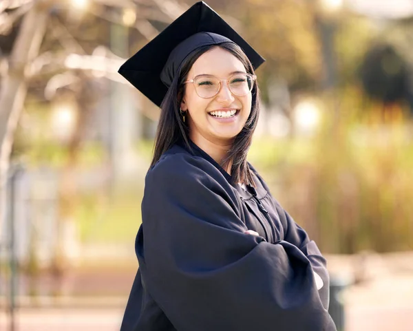 Stand tall knowing you gave it your all. Shot of a young woman celebrating graduation day. — Stock Photo, Image