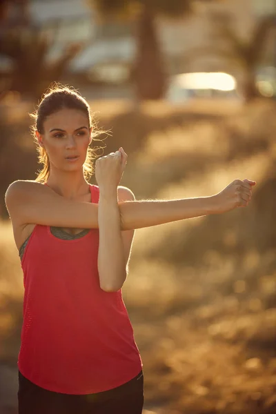 Its all part of the running lifestyle. Shot of a sporty young woman exercising outdoors. — Stock Photo, Image
