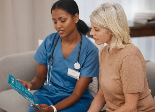 Tout le monde a le droit de savoir. Prise de vue d'un médecin lisant une brochure sur Covid-19 sur le canapé à la maison. — Photo