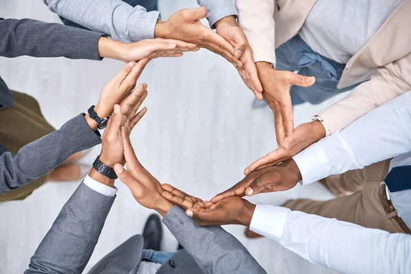 Collaboration helps everything fall into place. Shot of a group of businesspeople joining their hands to form a circle. — Stock Photo, Image