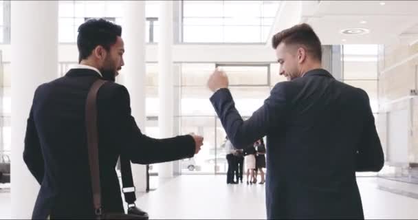 Nous avons conquis la journée ensemble. Vidéo 4k d'hommes d'affaires méconnaissables se donnant une pompe au poing dans le centre de conventions. — Video