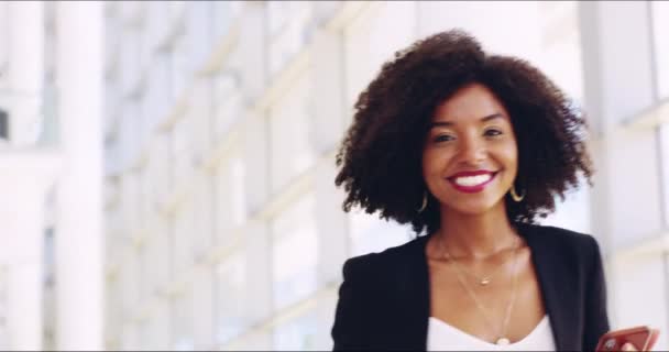 See you on the other side. 4k video footage of a young confident businesswoman walking and showing a friendly hand gesture to the camera at work. — ストック動画