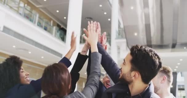 Were here to win. 4k video footage of a group of businesspeople giving each other a high five in an office. — ストック動画