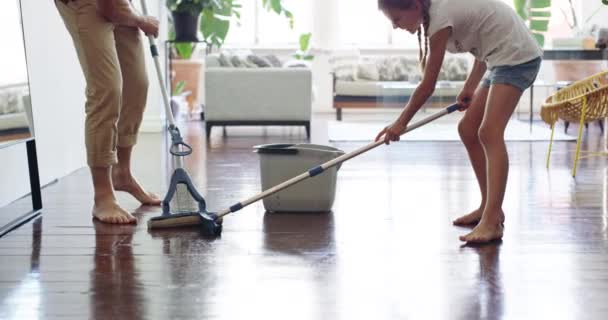 Teamwork makes the chores work. 4k video footage of a little girl mopping the floor with her father at home. — Vídeos de Stock