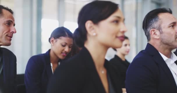 Broadening their knowledge and expertise in their field of work. 4k video footage of a young businesswoman sitting in a conference meeting. — Stok video