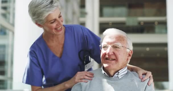 Shes got a special bond with her patients. 4k video footage of a mature female nurse talking to a wheelchair-bound senior male patient. — Stockvideo