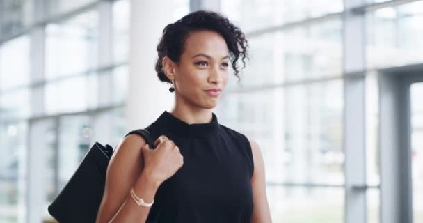 Clear the way, shes about to slay. 4k video footage of a confident young businesswoman walking through a modern office. — ストック動画