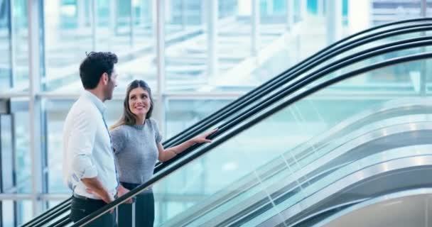 On their way up. 4k video footage of two businesspeople going up the elevator in an airport. — Wideo stockowe