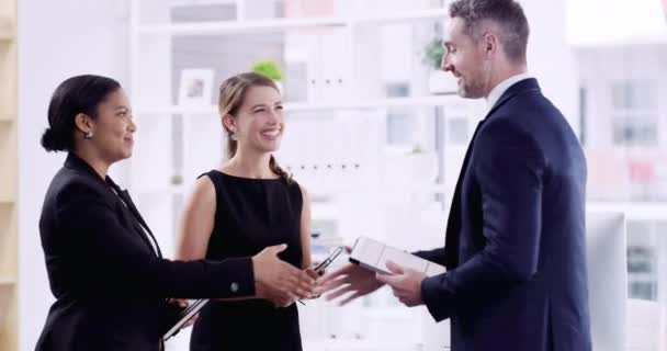 And with that, the merger is complete. 4k video footage of three well dressed businesspeople shaking hands in a corporate office. — Video