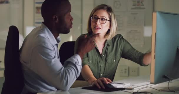 Trovare insieme delle idee innovative. 4k video di due colleghi che lavorano fino a tardi su un computer in un ufficio. — Video Stock