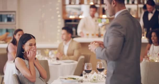 A great ending to a perfect dinner date. 4k video footage of a man proposing to his girlfriend while on a date at a restaurant. — Wideo stockowe