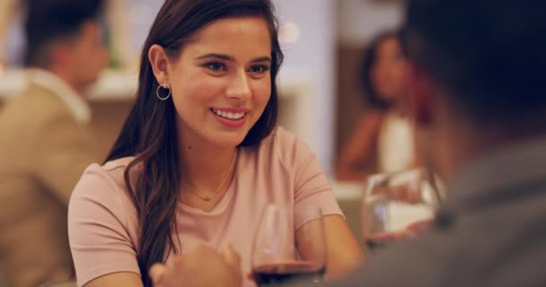 Cheers to seeing where the night takes us. 4k video footage of a couple sharing a toast while on a date at a restaurant. — Vídeos de Stock