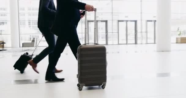 I go wherever my business takes me. 4k footage of a handsome young businessman walking with his luggage. — Wideo stockowe