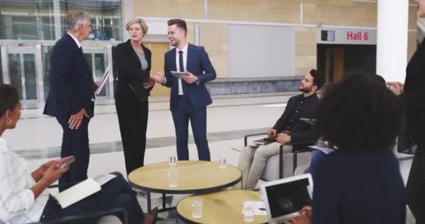 Shes just the person we needed on our team. 4k video footage of businesspeople shaking hands during a meeting in a modern office. — ストック動画